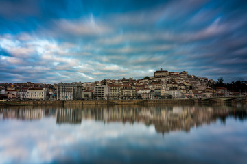 Fototapeta na wymiar Coimbra with a perfect mirror on the Mondego river