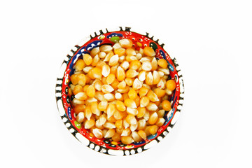 yellow round grains of natural dried corn in a decorative plate