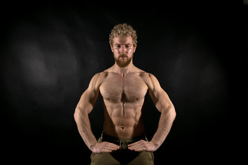 Beautiful muscles, athletic body. Studio photography on a black background, naughty light. Combat...