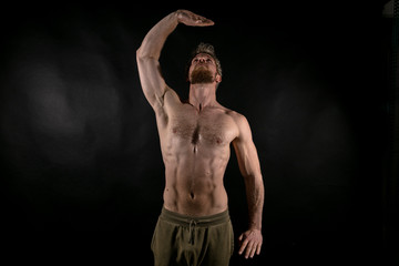 Beautiful muscles, athletic body. Studio photography on a black background, naughty light. Combat...
