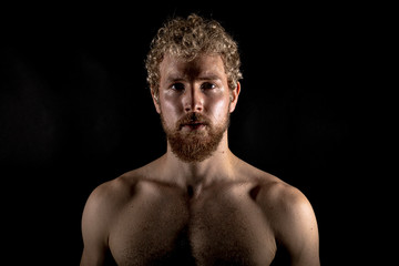 Beautiful muscles, athletic body. Studio photography on a black background, naughty light. Combat...
