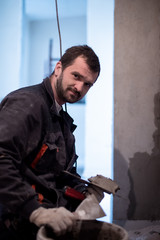 Worker plastering the wall by concrete