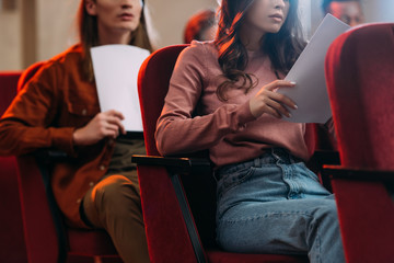 cropped view of actors and actress reading scripts in theatre
