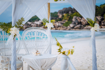 La Digue island, Seychelles. Decorated romantic wedding celebration accessories, table and chairs...