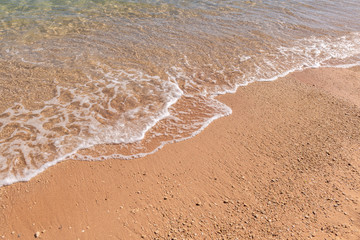 Sea wave on the beach on a sunny day