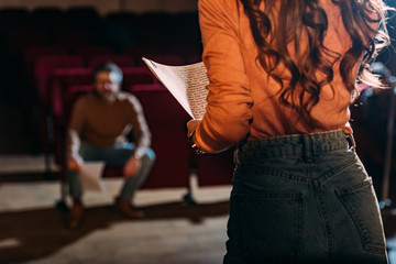 selective focus of theater director and actress with screenplay on stage