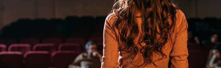 panoramic shot of stage director and actress in theater