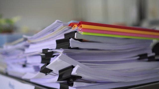 unfinished documents stacks of paper files on office desk for report papers, piles of sheet achieves with clips on table, Document is written, drawn,presented.