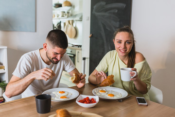 romantic couple having breakfast at home