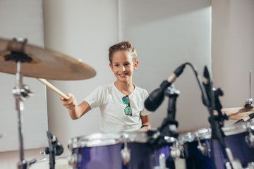 young boy playing drums at the music studio