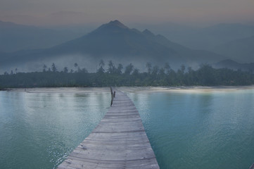 Wooden bridge on the sea tropical landscape with mountains 