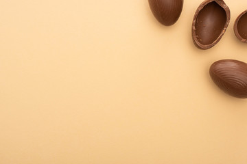 Top view of chocolate eggs on beige