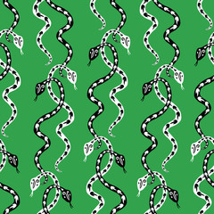 Seamless background of creeping decorative black and white snakes