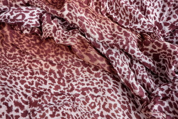 Designer background of a spotted leopard scarf. Texture