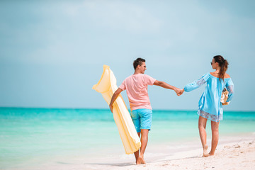 Young happy family during tropical beach vacation