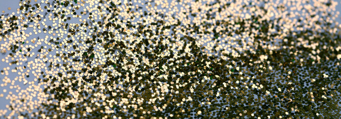 Abstract light blur blink sparkle defocus backgound. Gold (bronze) glitter shine dots confetti.