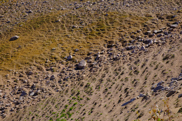 Sandy mountain slope with rocks. Abstract natural background.