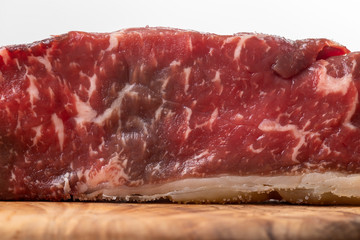 raw steak on olive wood