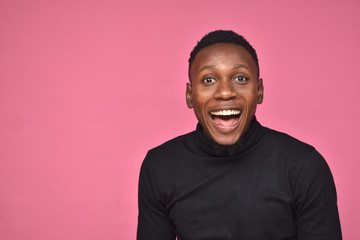 handsome young black man looking surprised and excited