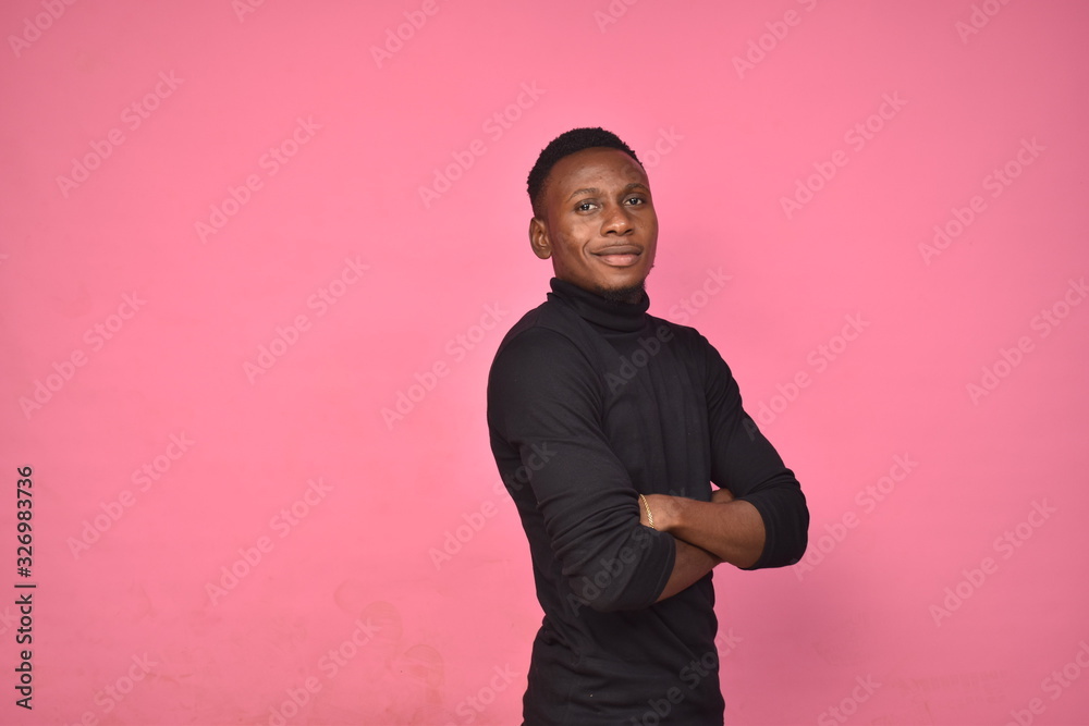 Wall mural confident young black man posing calmly, smiling