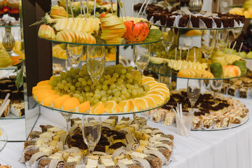 desserts with fruits, mousse, biscuits. Different types of sweet pastries, small colorful sweet cakes, macaron, and other desserts in the sweet buffet. candy bar for birthday