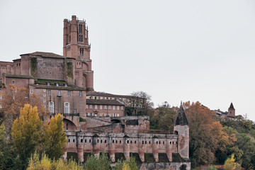 Huge walled cathedral with towers under a gray sky