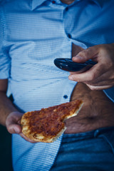 man with a beer belly eating pizza
