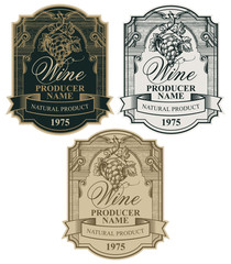 Vector set of wine labels with a bunch of grapes, a ribbon and a calligraphic inscription in a figured frame in a vintage style. Collection of ornate hand-drawn labels in three different colors