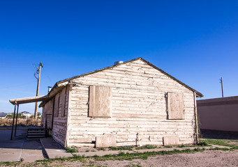 Old Weathered Home With Peeling Paint & Boarded Up Windows