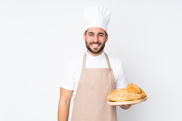 Male baker holding a table with several breads isolated on white background applauding