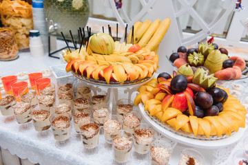 Delicious sweets on wedding candy buffet with desserts, cupcakes,tiramisu and cookies