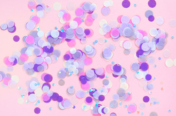 Festive pink background with violet confetti.