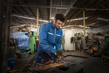 The welder is working in the factory.