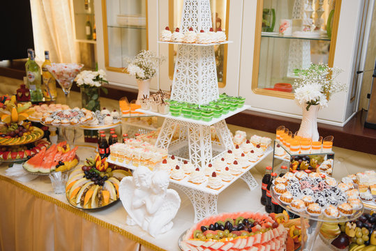 Delicious sweets on wedding candy buffet with desserts, cupcakes,tiramisu and cookies
