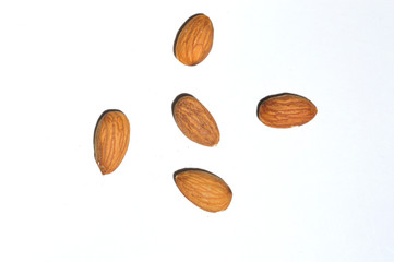 five almonds on a white background. View from above.
