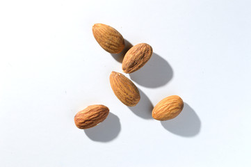 five almonds on a white background. View from above.