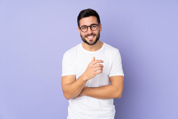 Caucasian handsome man over isolated background laughing