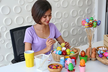 Asia young girls are painting paint on Easter eggs.