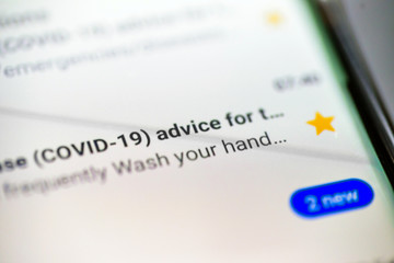coronavirus disease covid 19 email message on smart phone screen