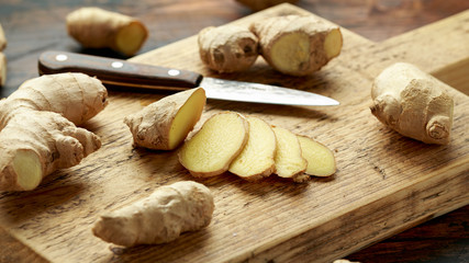 Fototapeta premium Fresh slice of Ginger on wooden chopping board. healthy food