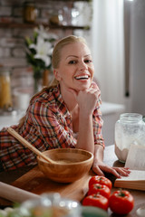 Woman in kitchen. Portrait of beautiful woman cooking. 