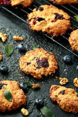 Home made Blueberry and walnut oat cookies on black background