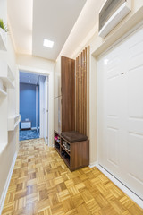 Interior of a bright long entrance corridor with parquet floor