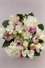 Springtime concept. Topview shot of a bouquet made of freesia, ranunculus and carnations