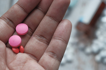 Close up of pill on person hand.