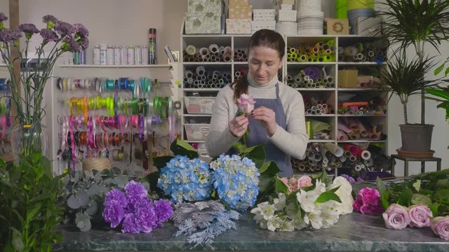 In the Studio of floral design woman florist at work.