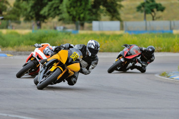 Motorcycle practice leaning into a fast corner on track