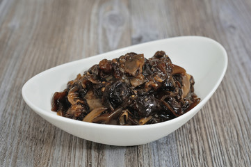 Pickled mushrooms in glass jar. Selective focus