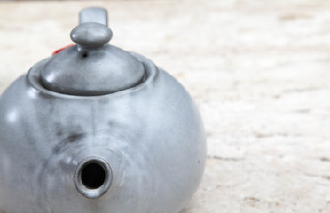 Gray ceramic chinese teapot closeup.