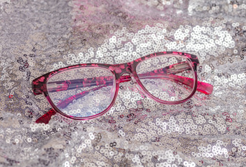 Pair of cheap reading glasses with pink frame